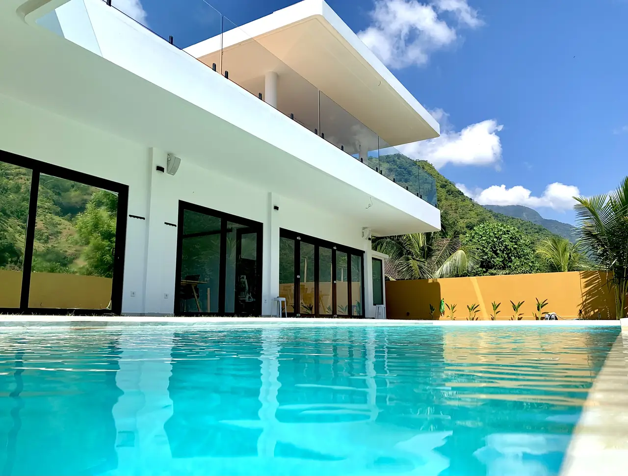Saltwater pool by day with mountain views