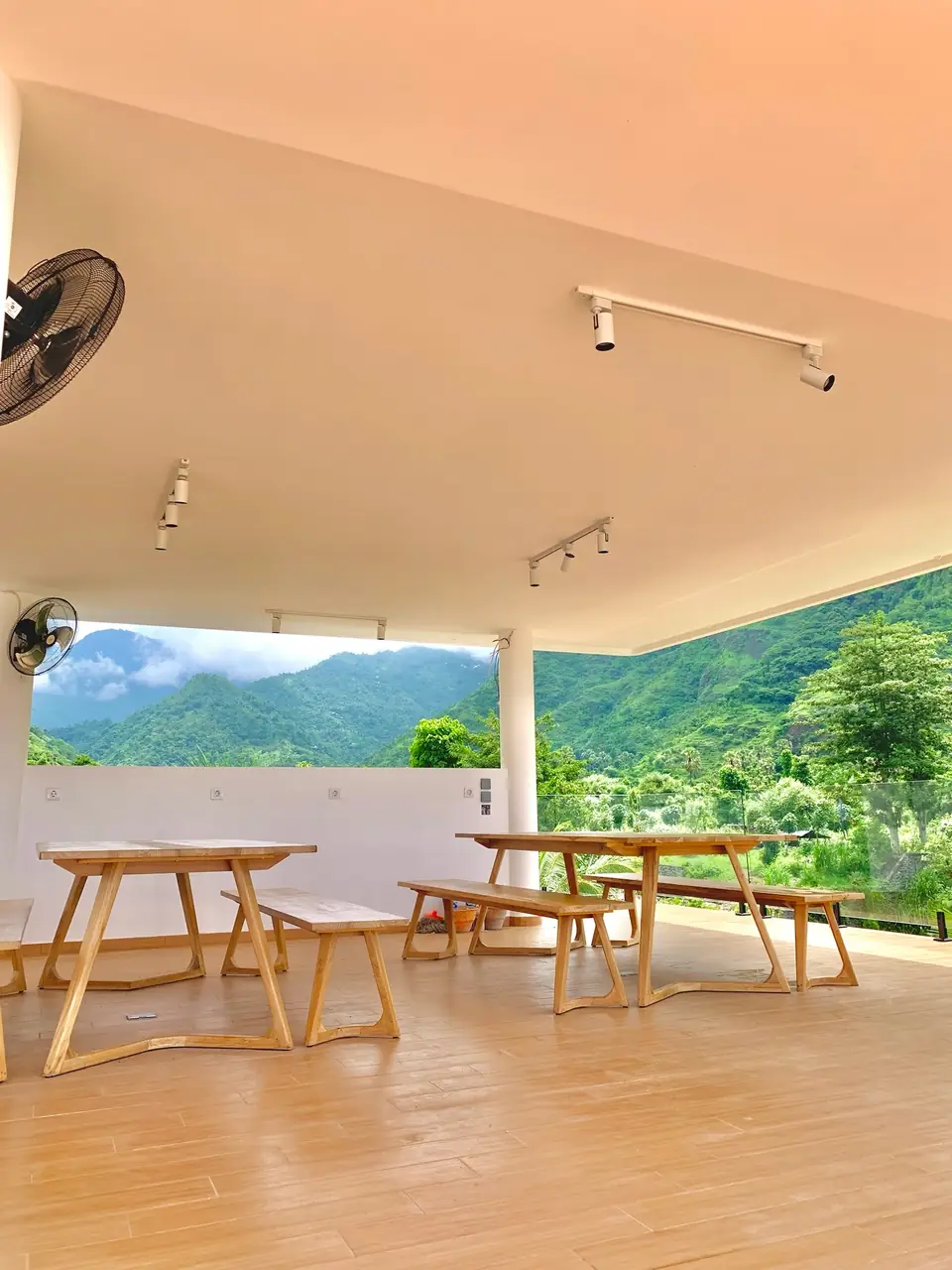 Covered terrace with wooden benches and valley view